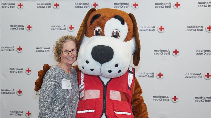 Nursing alumna Randy Miller poses with American Red Cross mascot, Fred Cross, during an event. Miller has been helping the community for more than four decades. Photos courtesy of American Red Cross